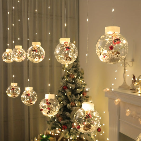 luzes com bolas de decoração de natal com pai natal dentro e árvore de natal